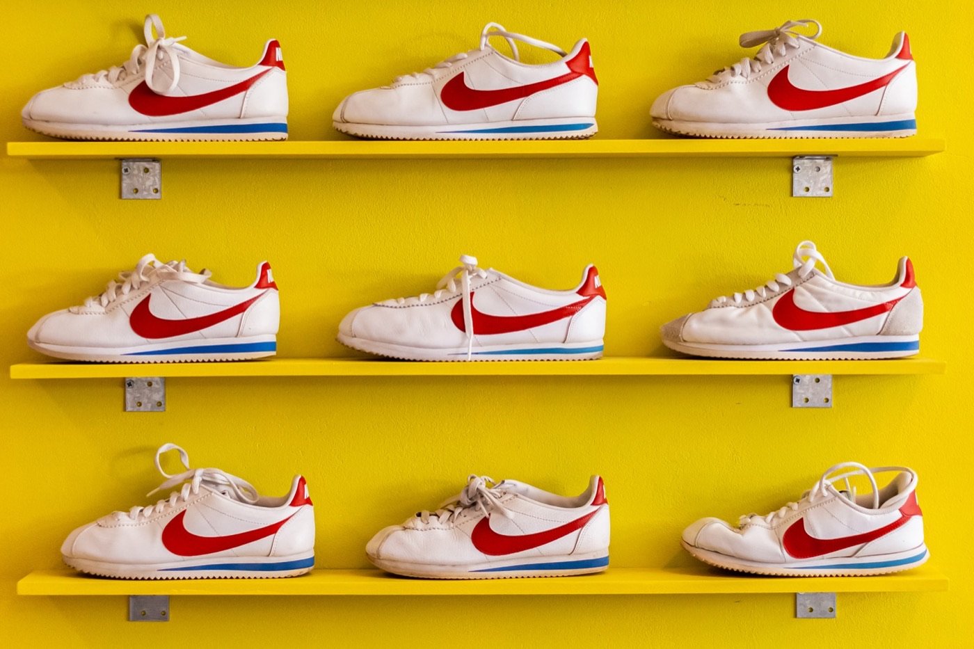 Rijen Nike Cortez op gele schappen in de winkel